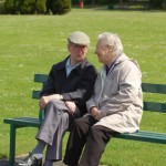 Senior couple chatting on a park bench