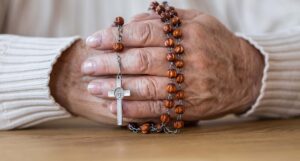 woman's hands with rosary