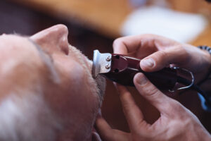 Electric shaver being used for beard trimming