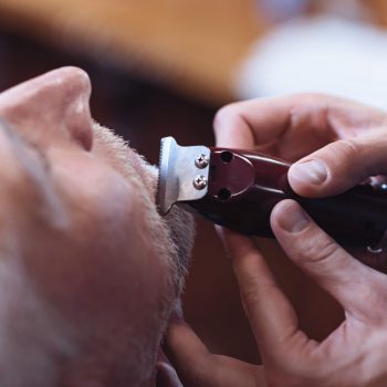 Electric shaver being used for beard trimming